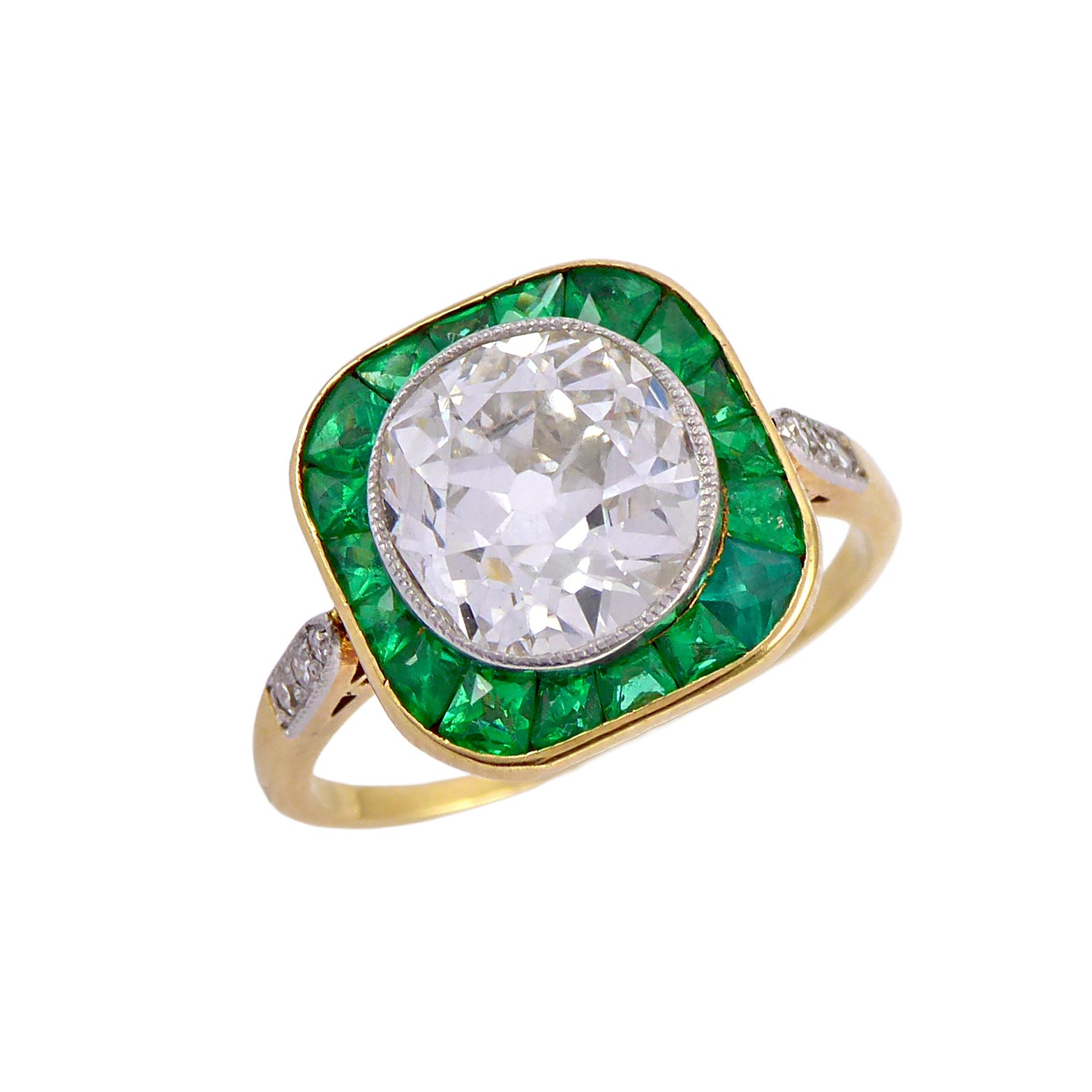 Early 20th century diamond and emerald cluster ring, c.1910, the principal old European cut diamond of approximately 2.00ct,